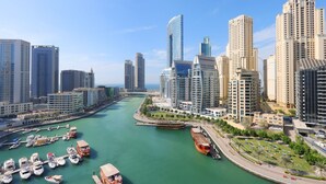 Un port de plaisance avec des bateaux et un paysage urbain caractérisé par des immeubles modernes de grande hauteur.