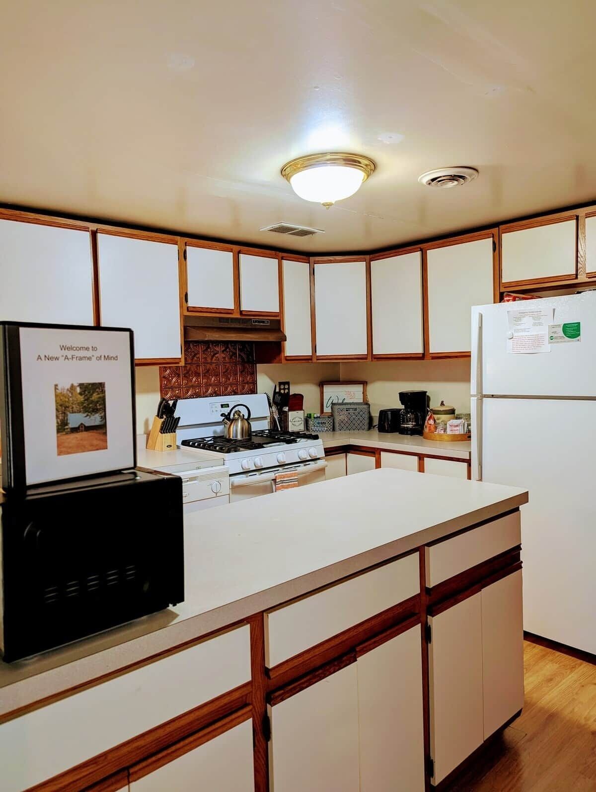 Coffee/tea maker, electric kettle, paper towels, dining tables