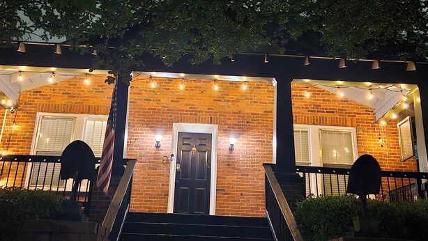 A brick building with a central door, two windows on either side, and a staircase leading up to the entrance. - Cozy Historic Home just 2 miles from USC, downtown and 6 miles from Ft. Jackson (Columbia)