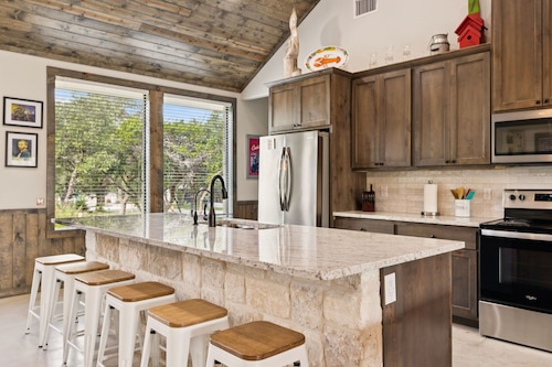 NOLA styled 6-bedroom home in Concan.  Sleeps 36 with AC, WiFi, Pool, Hot Tub