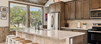 NOLA styled 6-bedroom home in Concan. Sleeps 36 with AC, WiFi, Pool, Hot Tub