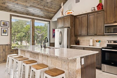 NOLA styled 6-bedroom home in Concan. Sleeps 36 with AC, WiFi, Pool, Hot Tub