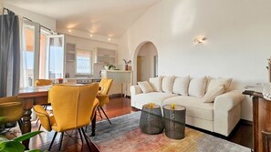 A modern living room with a sofa, chairs, and a dining table. - Special flat with sea view, air conditioning, WiFi, car park (Novigrad)