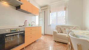 A kitchen with a built-in oven, a sink, and a window with a view.