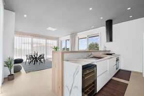 Fridge, stovetop, dishwasher, coffee/tea maker