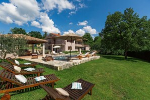 A two-story house with a swimming pool, outdoor seating, and a well-maintained lawn. - Charming property with private pool, large garden, table tennis, badminton court, BBQ, sun loungers (Tinjan)