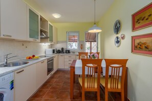 Enjoy meals in the kitchen with appliances and ample storage, then dine at the table near the window.