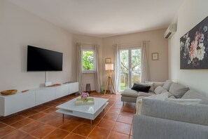 Relax in this stylish living room with a flat-screen TV, console table, and comfortable sofa.
