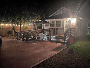A house with a covered patio area, a staircase, and a car parked in the driveway. - Summer and Early Fall Special Rates Camellia Cottage - Wheelchair Accessible (Monticello)