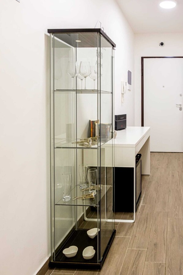 A modern kitchen with a glass display cabinet containing kitchenware. - LUXURY 2 (Bari)