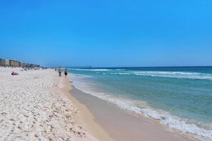 A beach with clear skies, a sandy shore, and a pier extending into the water. - Million Dollar Gulfview (Fort Walton Beach)