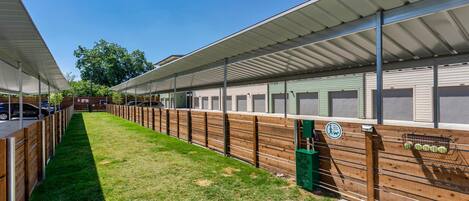 Uma fileira de casas móveis térreas com galeria coberta e área gramada.