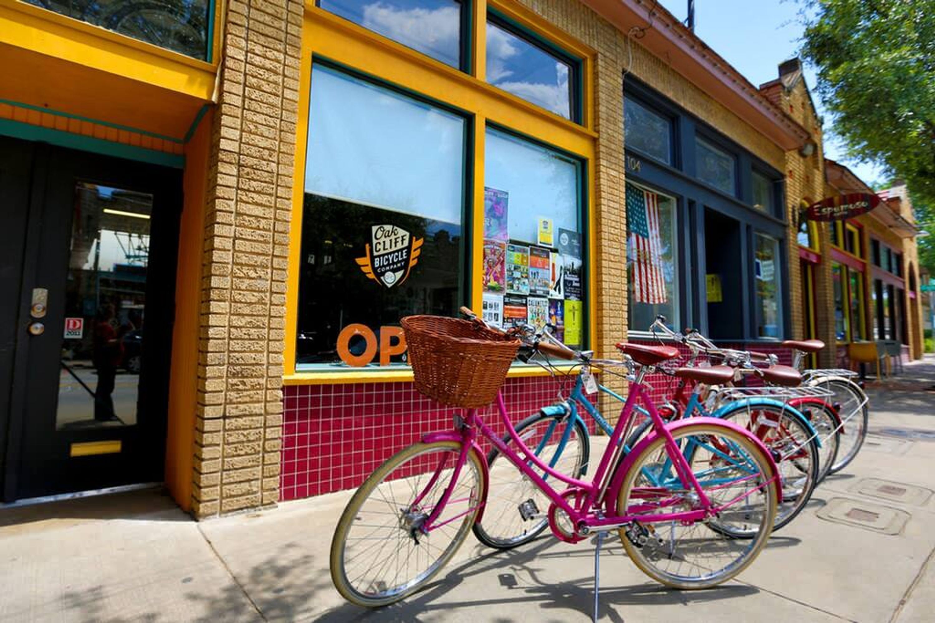A storefront with a bicycle rental service, a red tiled facade, and a window displaying various items.