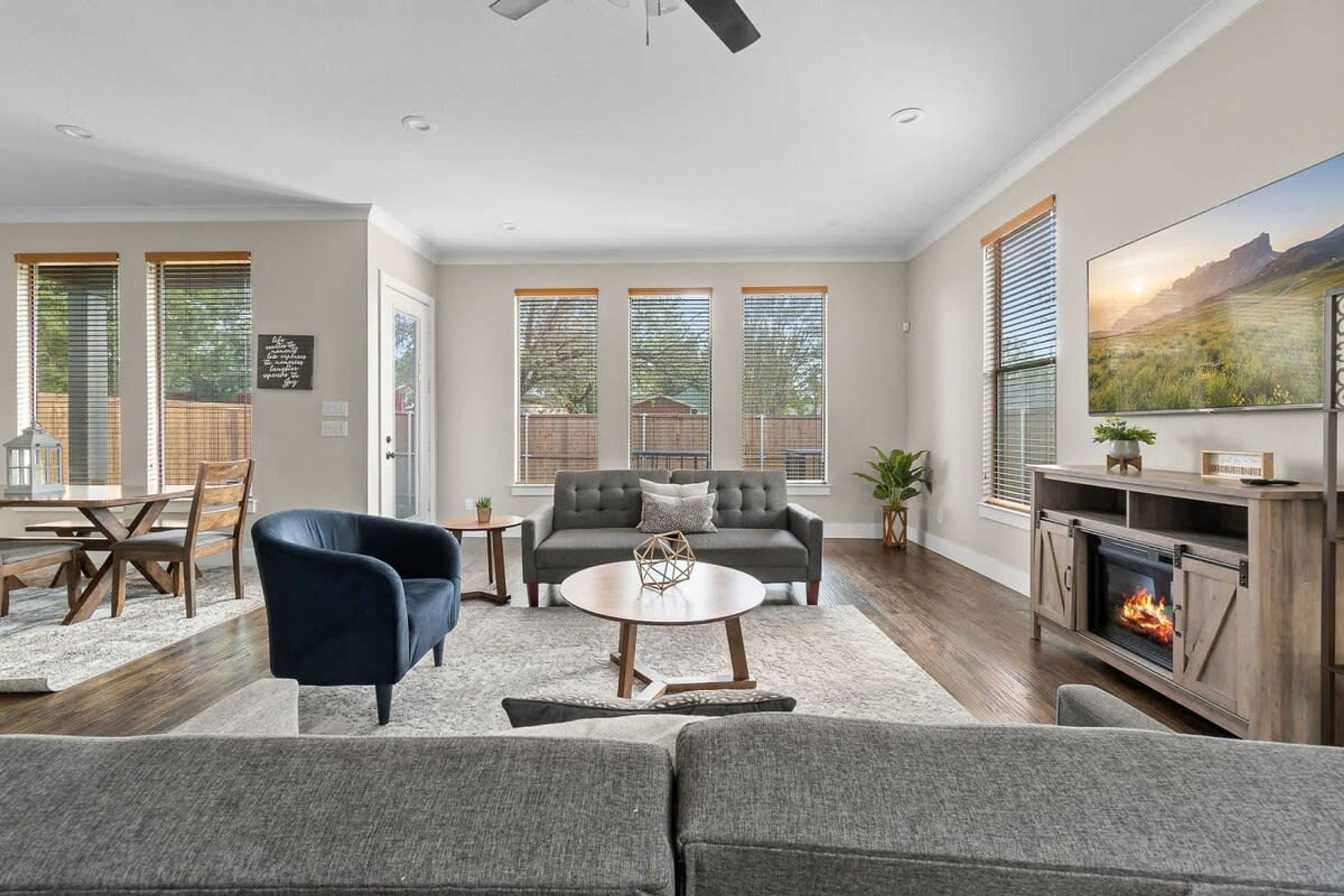 A spacious living room with a fireplace, a sofa, a coffee table, and a television.
