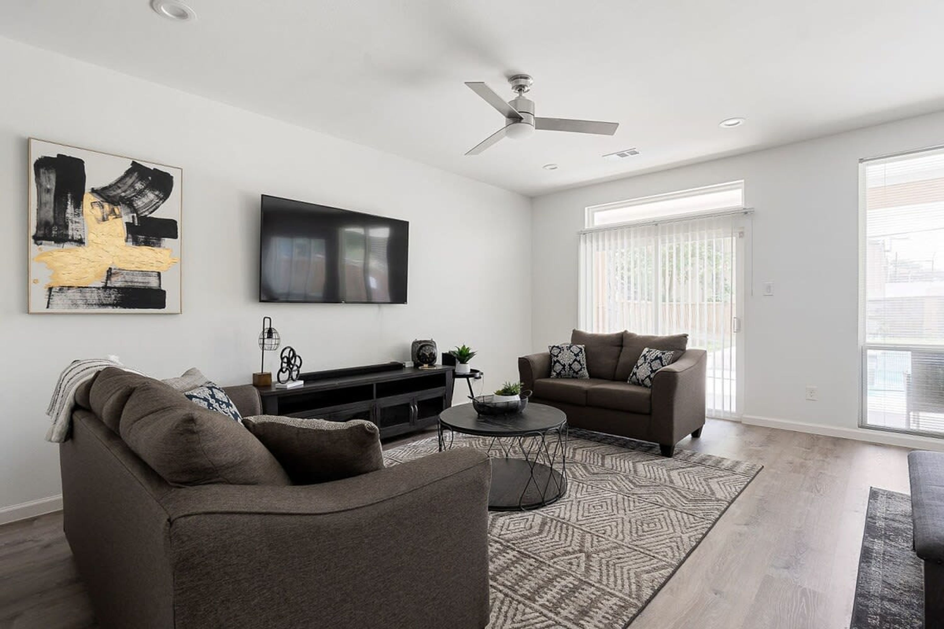 A modern living room with a sofa, a coffee table, and a TV.
