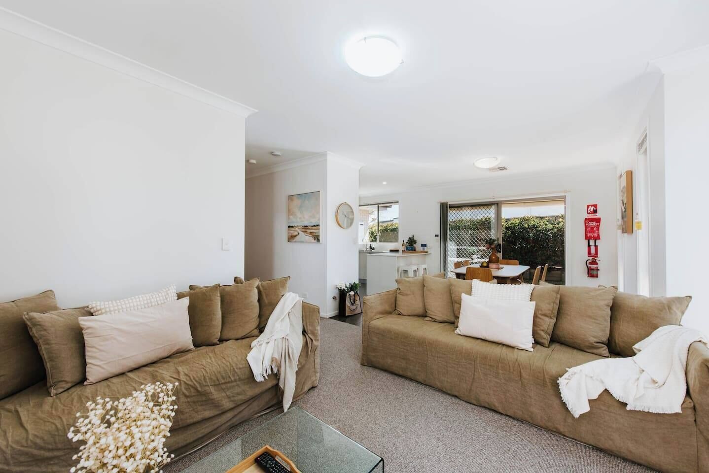 Get cosy in the living room with two linen-clad sofas allowing you to relax in air-conditioned comfort. 
