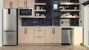 A modern kitchen with a refrigerator, microwave, and dishwasher. - Branson's Perfect Luxury Romantic Getaway (Branson)