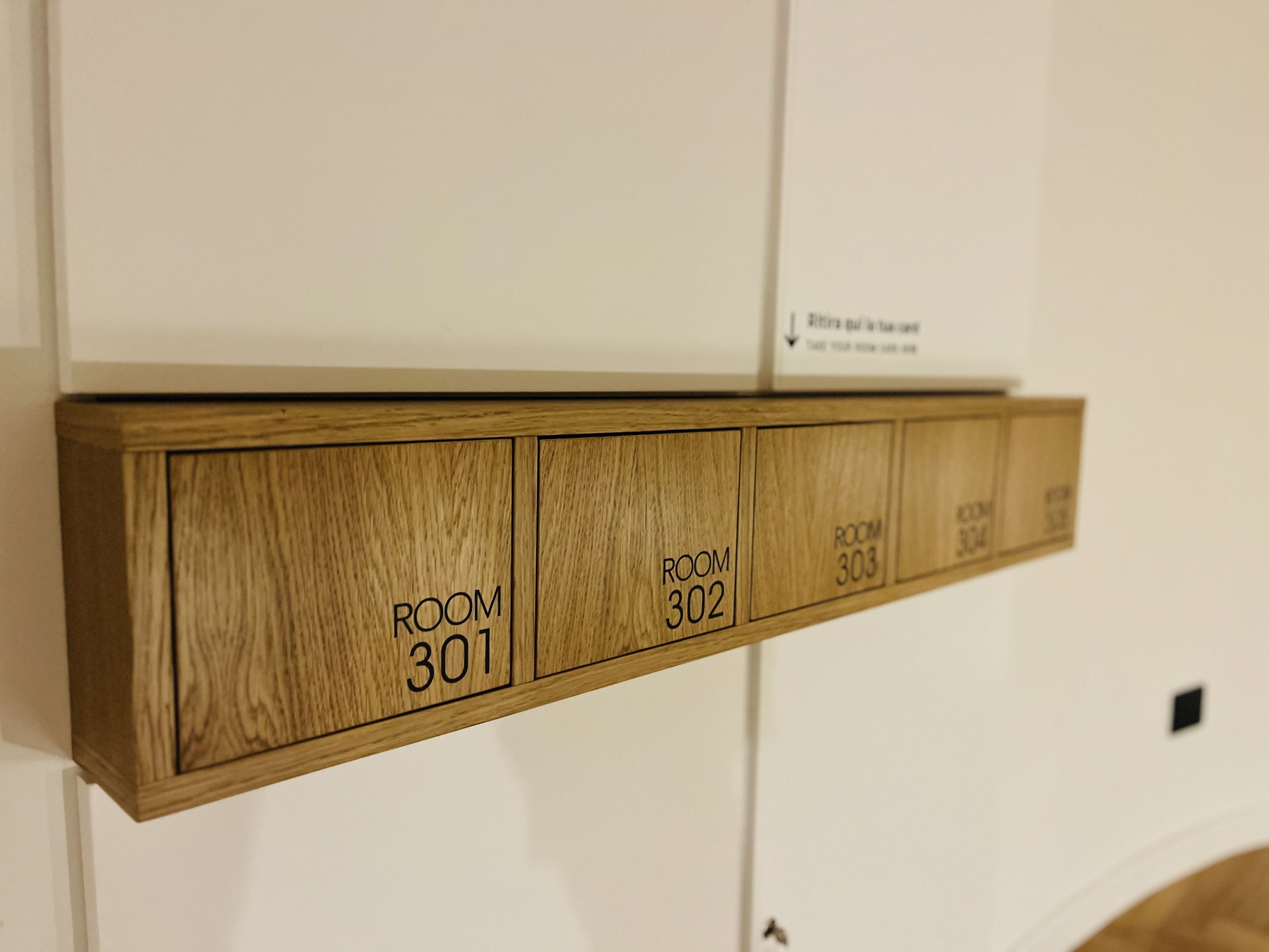 A wooden panel with room numbers 301 and 302.