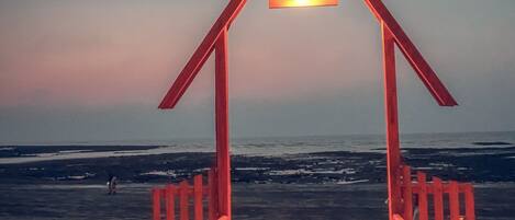 A wooden beach structure with a sign reading "FAMILY TIME" and a view of the ocean.