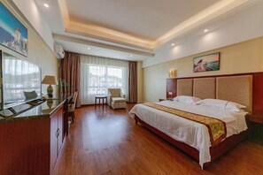 A hotel room with a bed, a desk, a chair, a television, and a window with curtains. - Qiongzhong Runfeng Business Hotel (Qiongzhong)