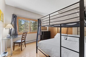 A bunk bed room with a desk and chair, a window with curtains, and a dresser. - Walk to town and slopes, family friendly 2-bedroom condo w/ WiFi in Breckenridge (Breckenridge)
