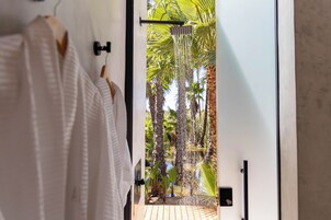 Separate tub and shower, hair dryer, slippers, towels