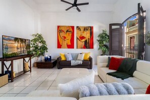 A modern living room with a sofa, coffee table, and artwork on the wall.