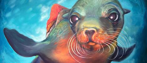 A large painting of a seal in an underwater setting.