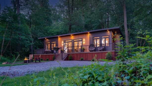 A cabin with a deck, outdoor seating, and a fire pit. - Woodland Chalet  Hot Tub  Fire Pit  Grill (Quarryville)