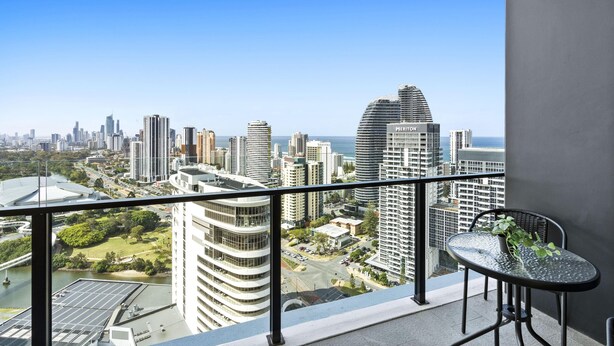 A balcony with a view of a cityscape, including high-rise buildings and a river. - Cozy 2 Bedroom Unit in Broadbeach (No Parking) (12801 - 2N - NB) (Broadbeach)