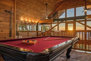 A pool table with a red felt surface, wooden ceiling, and large windows with a view of the sunset. - Best Views in Sevierville! 1b/2ba + Loft! Hot Tub. 15 min to Pigeon Forge! (Sevierville)