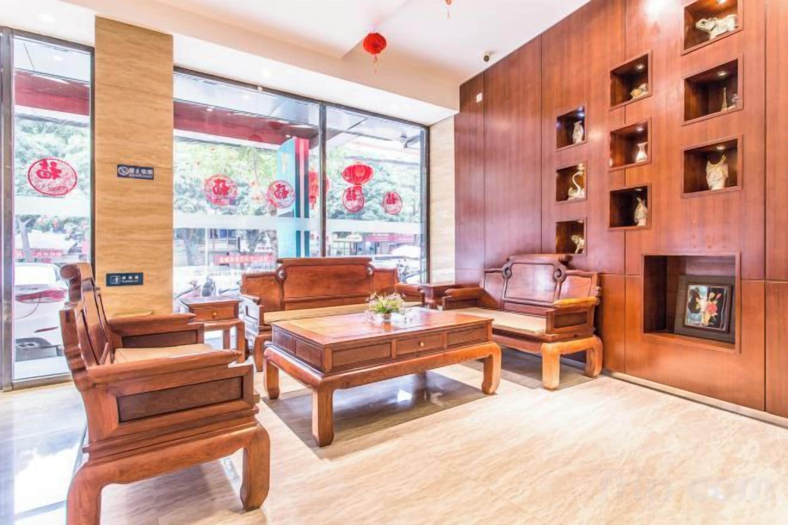A traditional wooden interior with a sofa, a coffee table, and a fireplace.