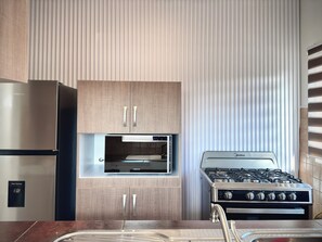 Fridge, microwave, stovetop, coffee/tea maker