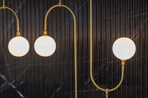 A modern chandelier with three spherical light fixtures. - Luxembourg Marriott Hotel Alfa (Luxembourg City)