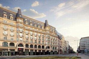 A multi-story hotel with a classic European architectural style, featuring arched windows and balconies. - Luxembourg Marriott Hotel Alfa (Luxembourg City)