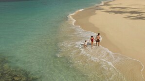 A beach with clear water and a sandy shore. - Donoma Las Terrenas Resort & Villas Autograph Collection (Las Terrenas)