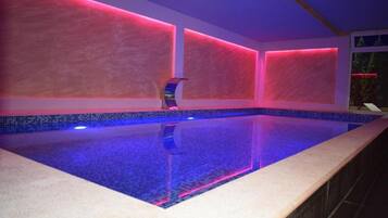 Relax by the pool surrounded by a minimalist design and vibrant LED lighting.
