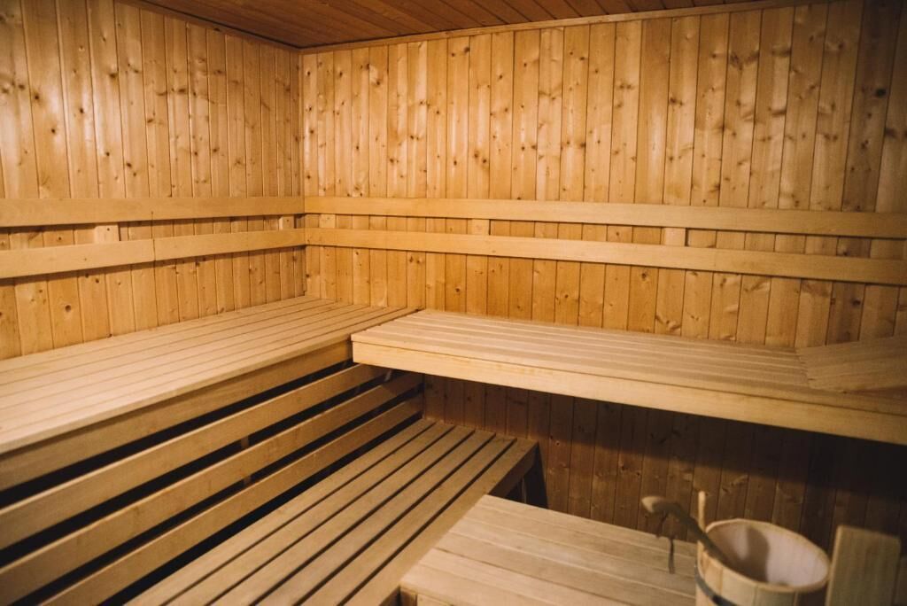 Eine Sauna mit Holzbänken und einer Sitzbank.