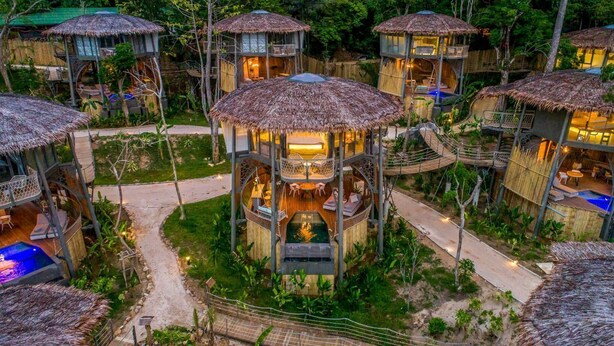 A treehouse-style resort with multiple levels, outdoor seating areas, and a central water feature. - TreeHouse Villas - TreeHouse Villa (Ko Yao Noi)