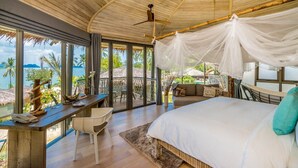 A bedroom with a bed, a desk, and a chair. - TreeHouse Villas - TreeHouse Villa (Ko Yao Noi)