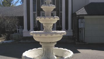Stunning fountain adorns the entrance of this elegant residence.