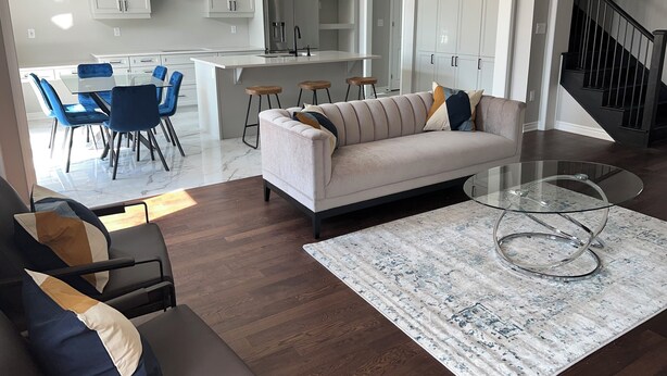 Un salon moderne avec un canapé, une table basse et un coin repas.