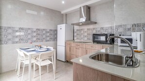 A modern kitchen with a built-in oven, microwave, and sink. - Beautiful home in Conil de la Frontera (Conil de la Frontera)