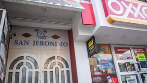 A building facade with a sign for "Casa San Jeronimo" and a "WJU" sign above it. - Casa San Jeronimo (San Pedro Mixtepec)