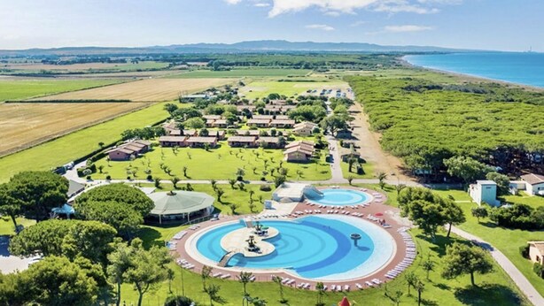 A resort with multiple swimming pools, a golf course, and a beach view.