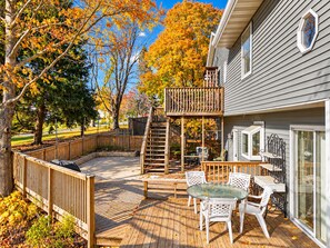 A deck with outdoor furniture and a staircase leading to a deck area.