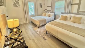 Un dormitorio con dos camas, un ventilador de techo y una lámpara.