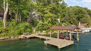 A dock extending into a body of water with boats moored at the end. - Lone Retreat Lake House: New Build + Close to Ithaca (Interlaken)
