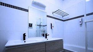 Shower, hair dryer, towels, shampoo