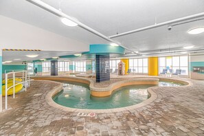 Una piscina interior con varias pistas de natación, una plataforma de salto y un indicador de profundidad de 3 pies.